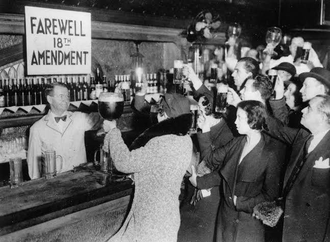 Patrons in a beer holding a toast to the repeal of the 18th Amendment. 