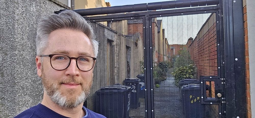 Cllr Gary McKeown beside a newly installed alleygate 