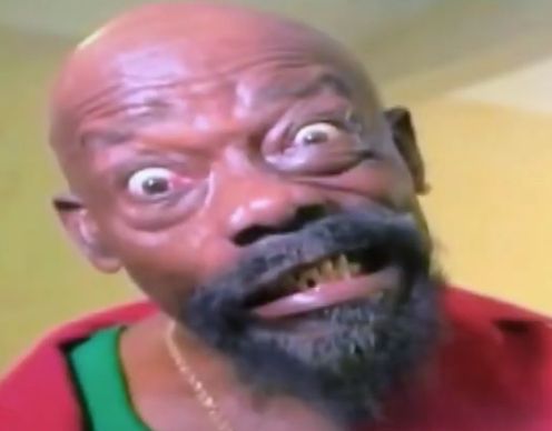 Close-up of the man Lord Brigo, a calypsonian from Trinidad and Tobago, with a bald head, wide eyes, and black beard.
