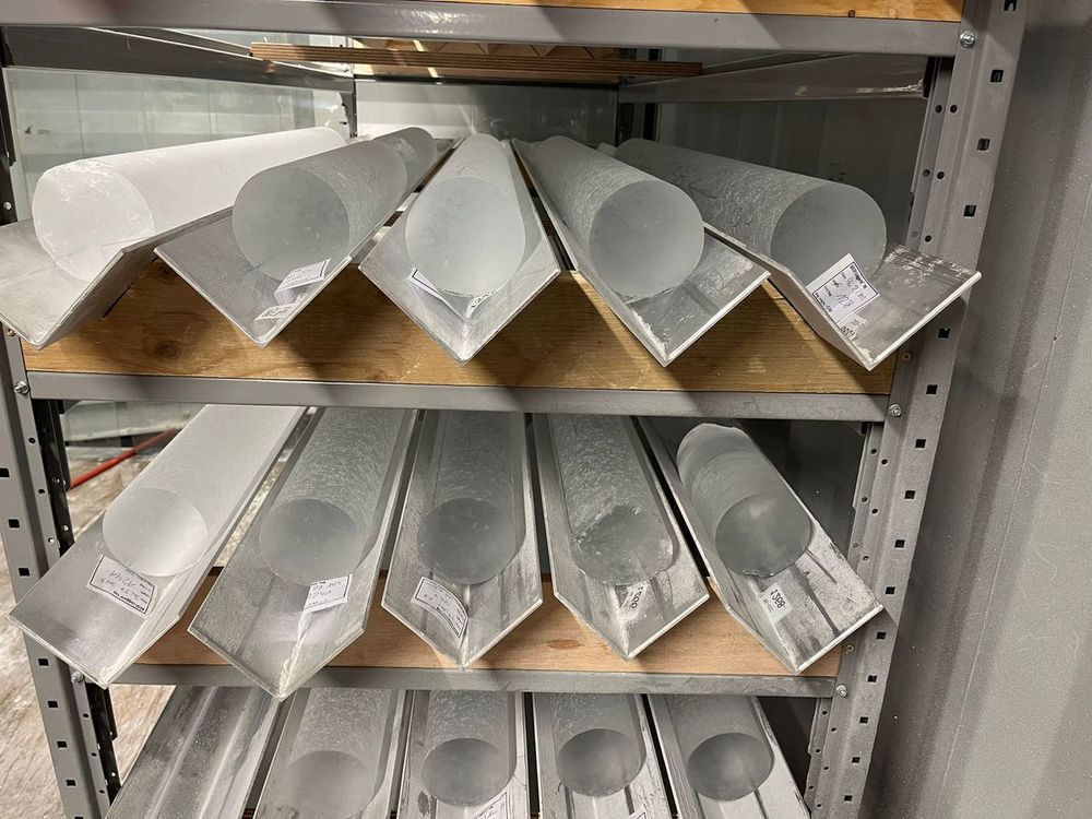 A rack of ice cores on shelves. They are around 25cm wide and each a metre long. (Credit: PNRA:IPEV)