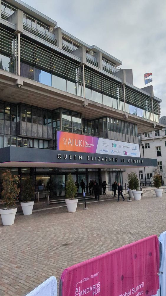 The front of a large building with wording The Queen Elizabeth Conference Centre on the front.