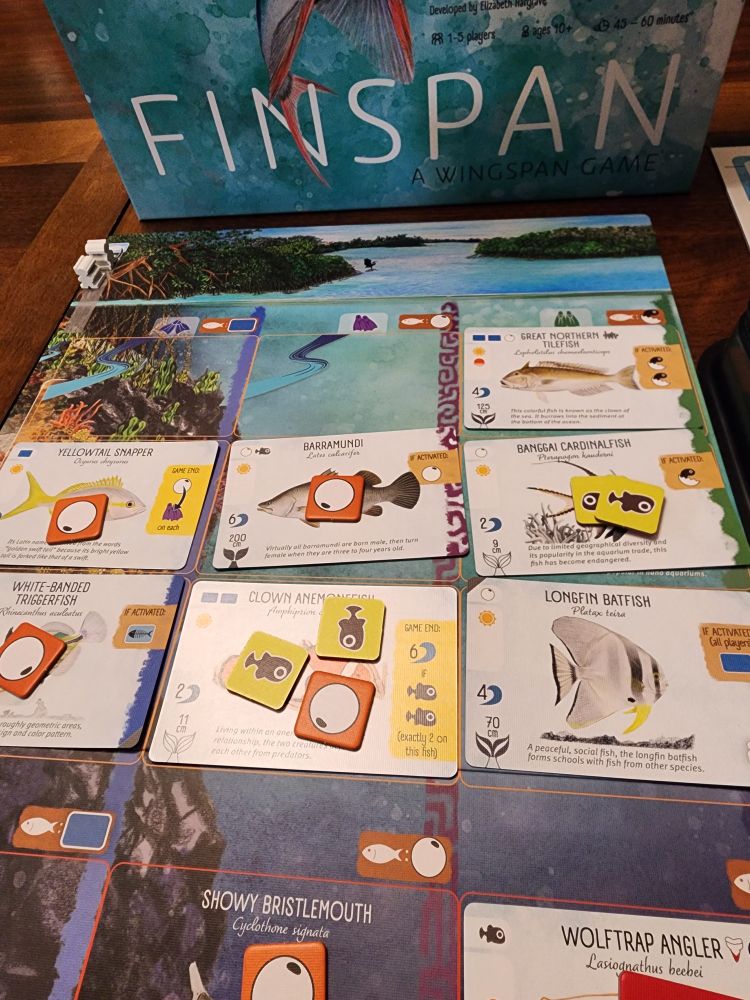 End game ocean board for a solo play of Finspan featuring 8 fish cards along with young fish and egg tokens