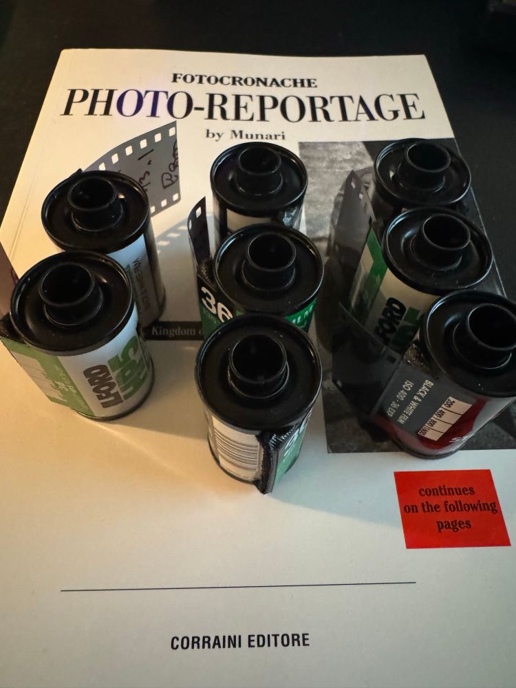 Rolls of film about to be processed on top of a photo book