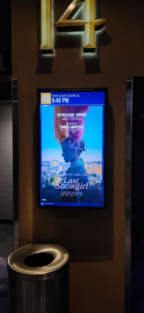 A poster from the movie The Last Showgirl, showing Pamela Anderson dressed up in a showgirl costume 