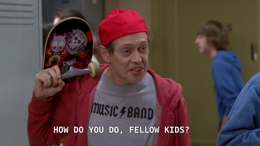 Steve Buscemi in a scene from 30 Rock, dressing how he thinks kids dress to blend in with students at a school, asking them, “How do you do, fellow kids?”