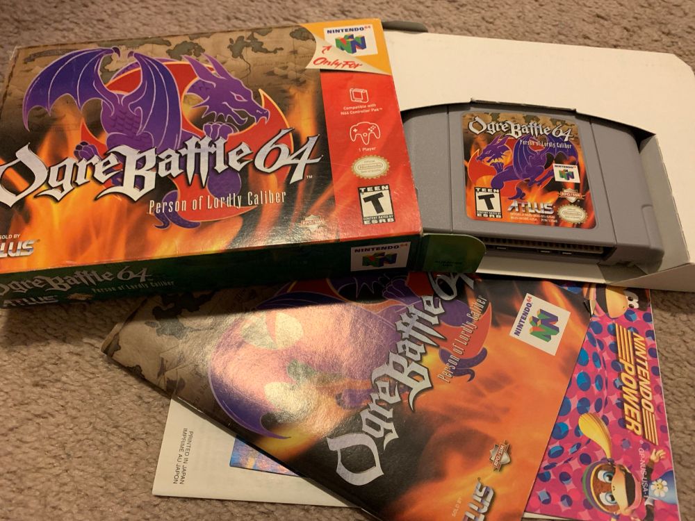 Photo of Ogre Battle 64, along with the box it comes in and manuals, spread out on the floor.