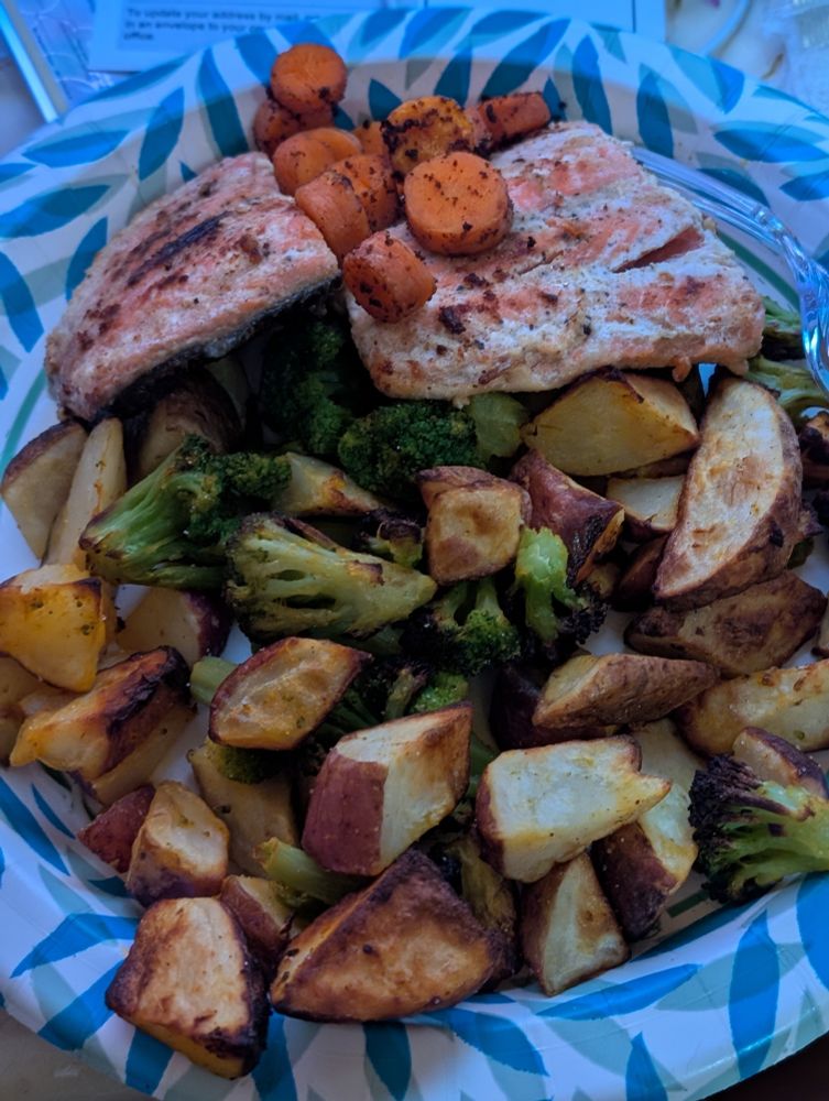 Sockeye salmon cooked in butter and garlic with potatoes and broccoli and carrots