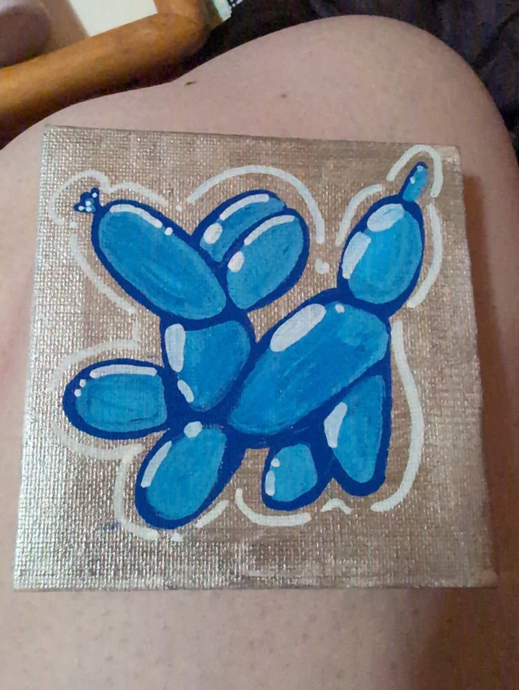 Little blue balloon dog who is happy to see you
