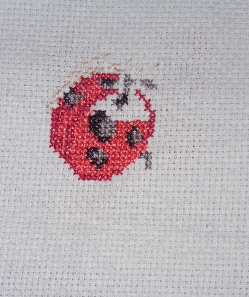Ladybug with one leg. Freebie kit from World of Cross Stitch.
