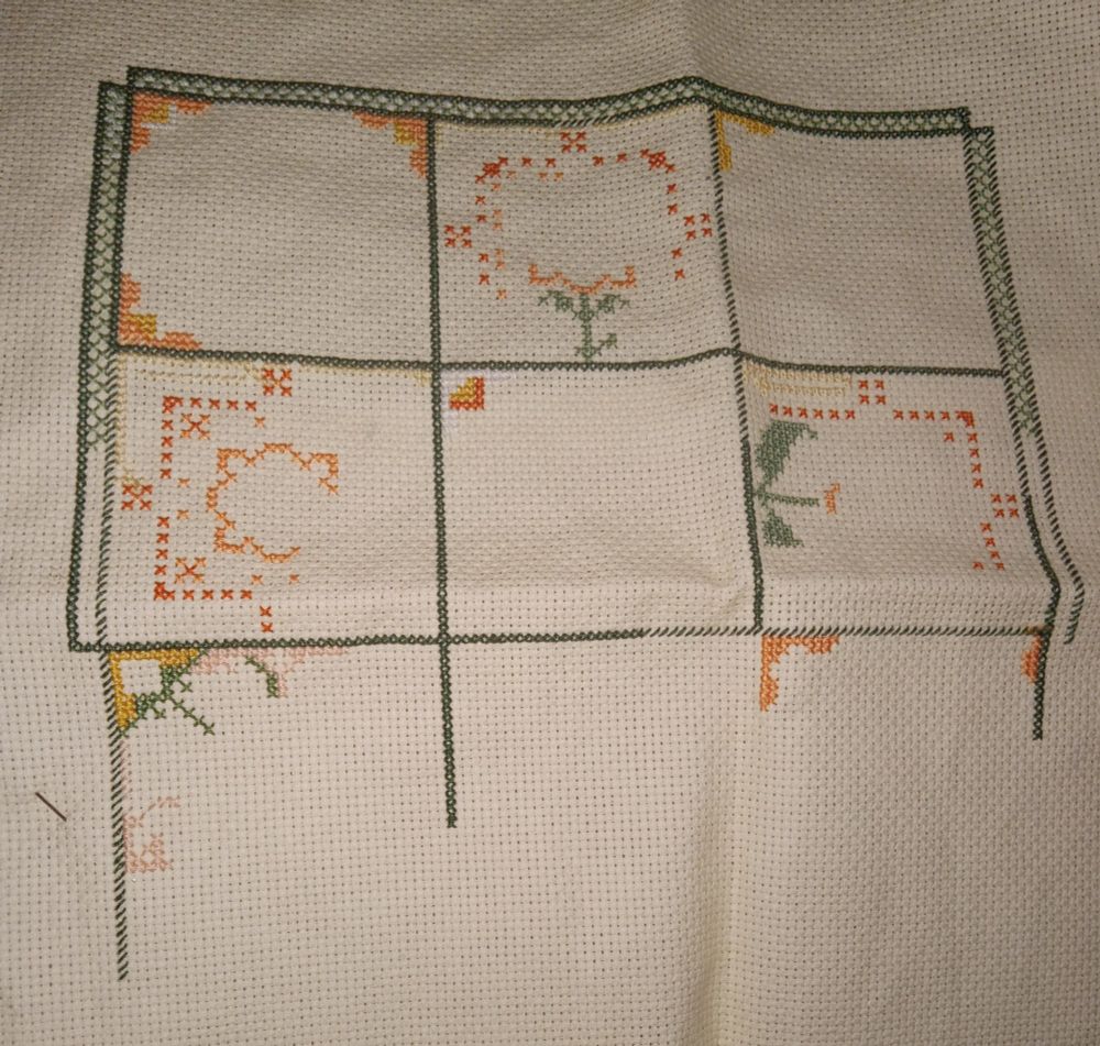 Some green squares outlined with the beginnings of flowers in them. "Marmalade" by Carolyn Manning 