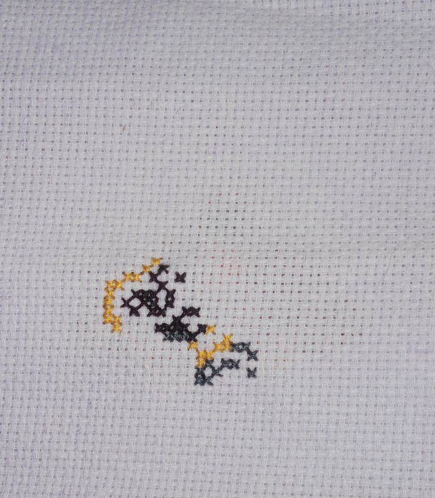 Black and yellow stripes that will be a bumblebee. Freebie kit from World of Cross Stitch.