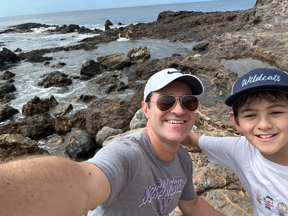 Johnny and his son taking a selfie in front of some Lunada Bay tide pools