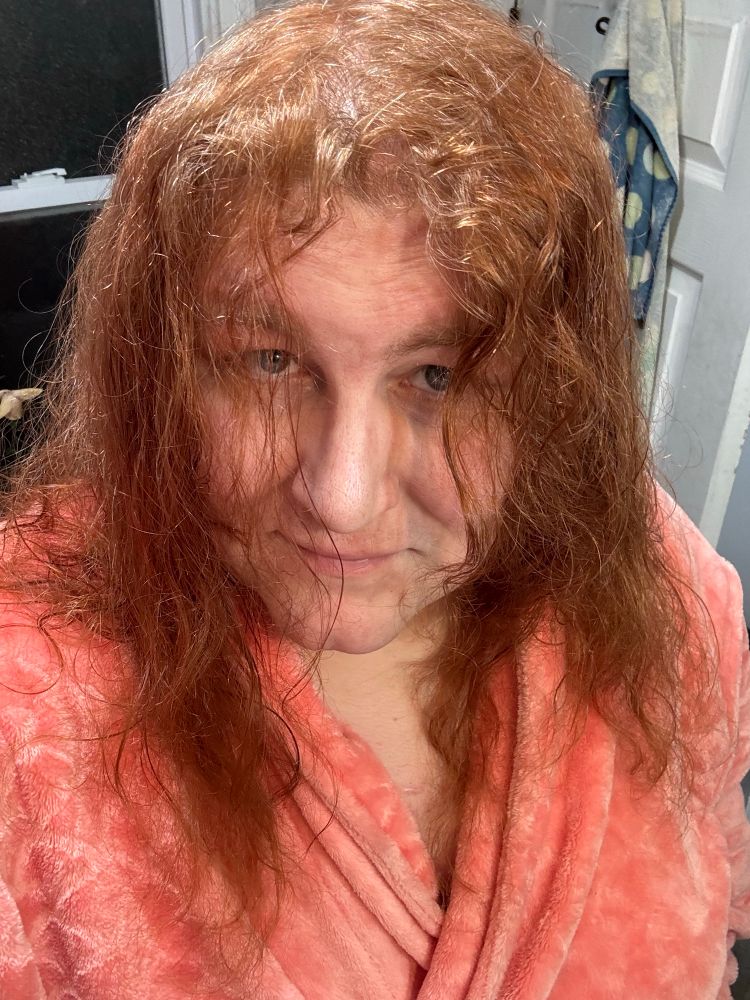 Amanda wearing her bathrobe, hair dyed and looking like a rich copper