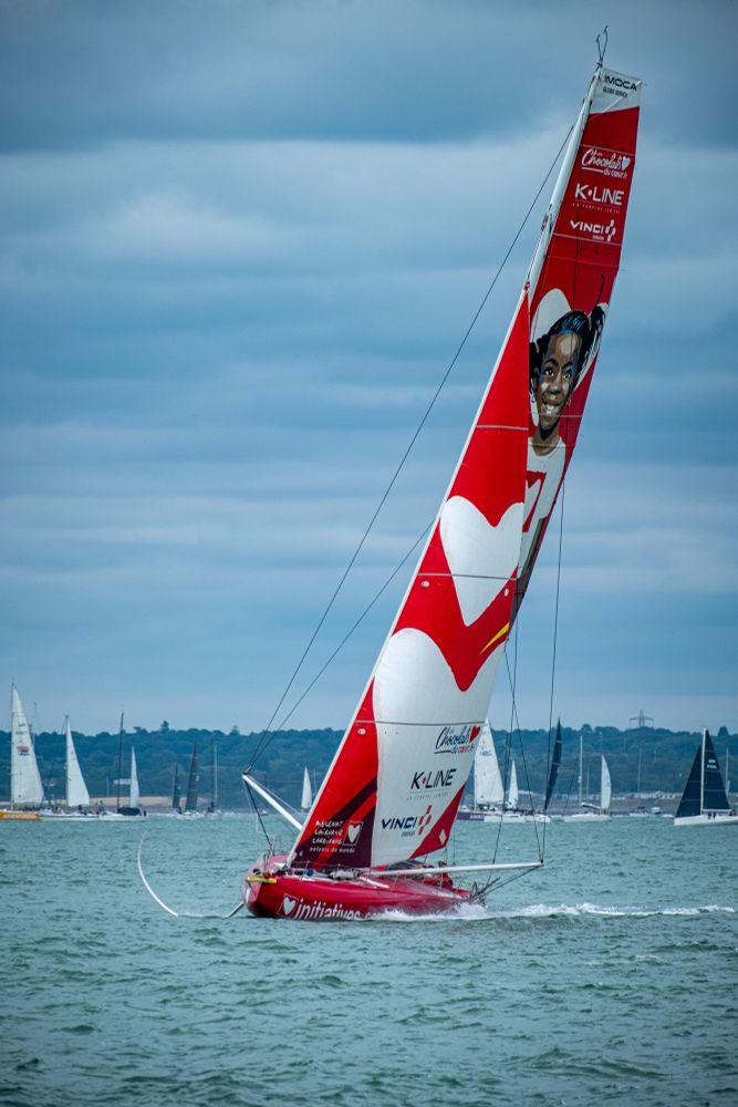 A red sailing vessel with hydrofoil blades
