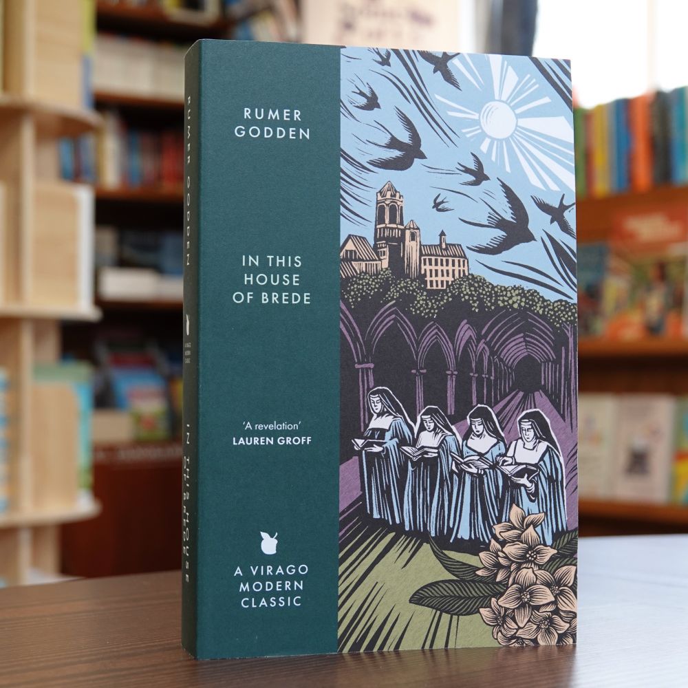 Rumer Godden, In This House of Brede (Virago Modern Classic) on the bookshop counter with bookshelves behind