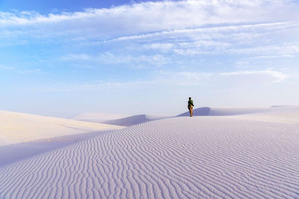 White Sands National Park has white gypsum dunes, sand sledding, and moonlit hikes in surreal landscapes. Here's what to know before you visit.