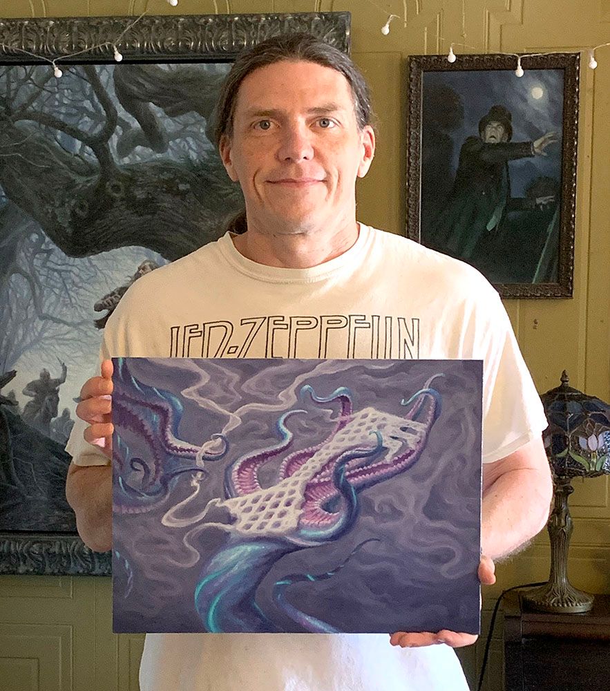 Matt holds his painting 