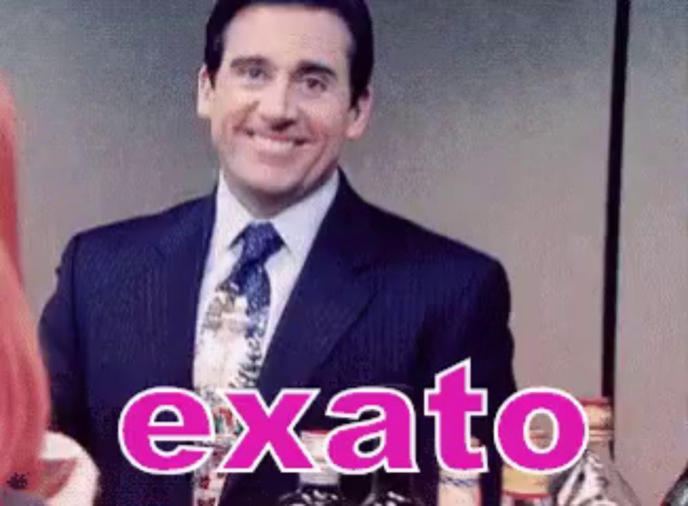 a man in a suit and tie is smiling with the word exato written in pink .