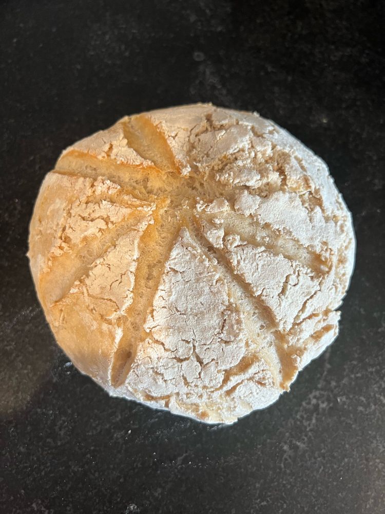 A homemade loaf of bread on a countertop. 