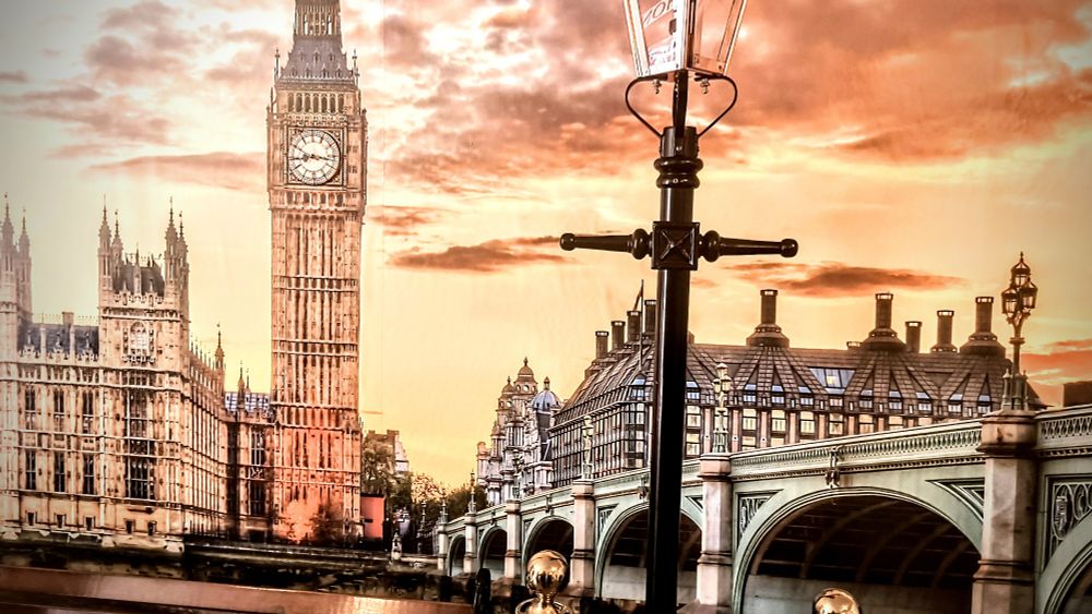 A picture of the wall clock from Love from London featuring a beautiful art picture with a telephone pole in front of it and a clock in Big ben.