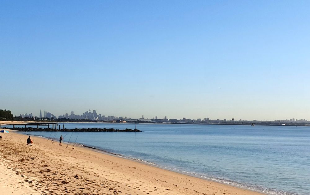 Photo of a Sydney beach with the CBD in the background 