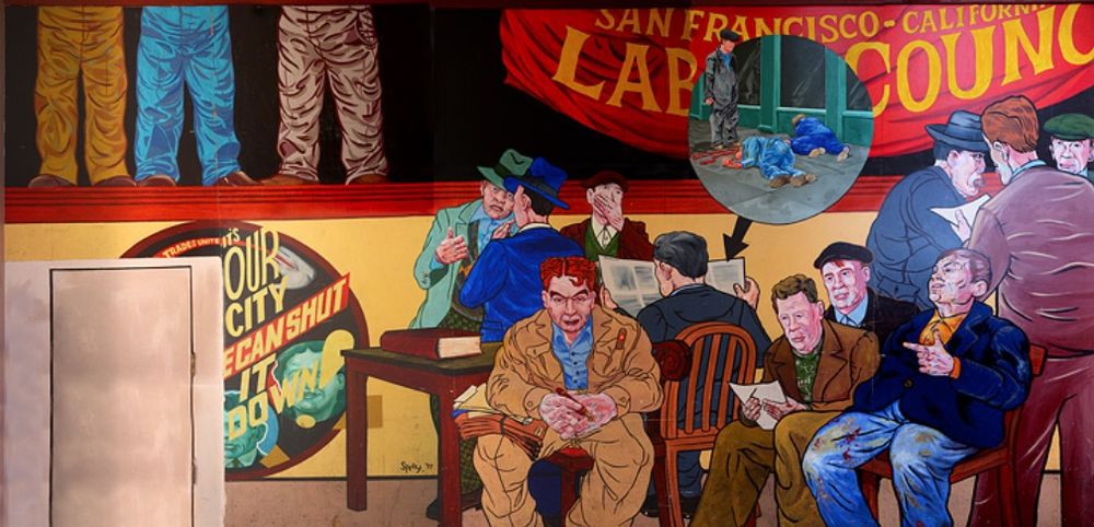 The mural depicts workers talking and reading, with a zoomed-in bubble showing the two longshoremen (Nick Bordoise and Howard Sperry) killed in the strike, lying on the pavement in a pool of blood.