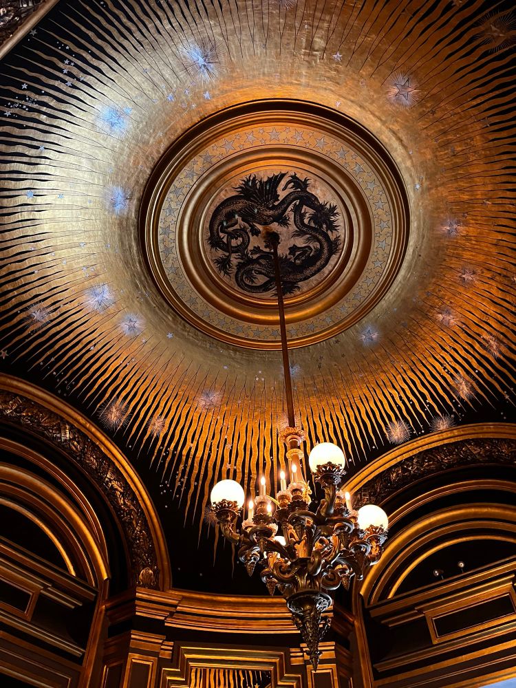 Dragons dance in the sun on this ceiling mural in an alcove. 