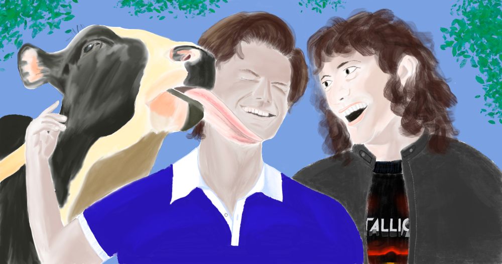 A cow is licking Steve Harrington's face while Eddie Munson, beside him, laughs.  Steve's eye's are squeezed shut as he tries to move away, but he's also laughing.