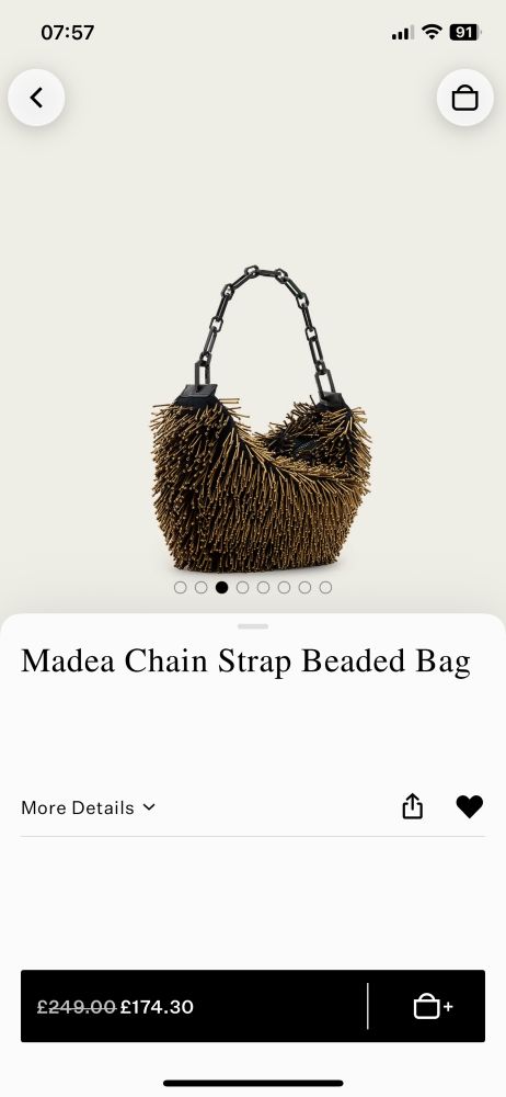 A bag covered in long beaded fringing with a chunky chain strap. 