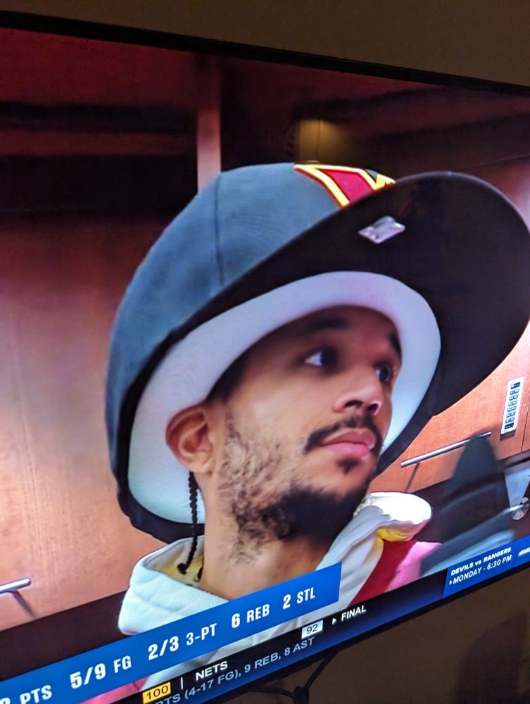 Josh Hart wearing an oversized Washington Commanders baseball cap