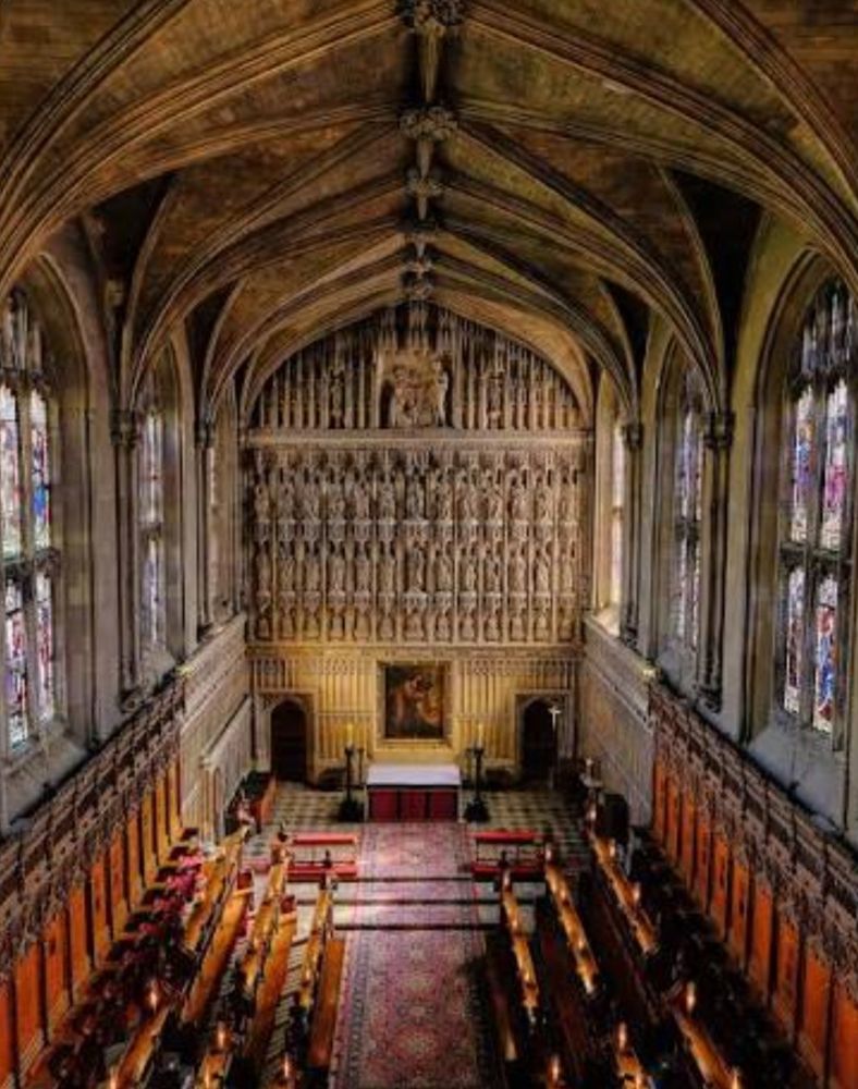 Stone gothic chapel with an elaborate reredos- a carved stone screen with rows of figures.