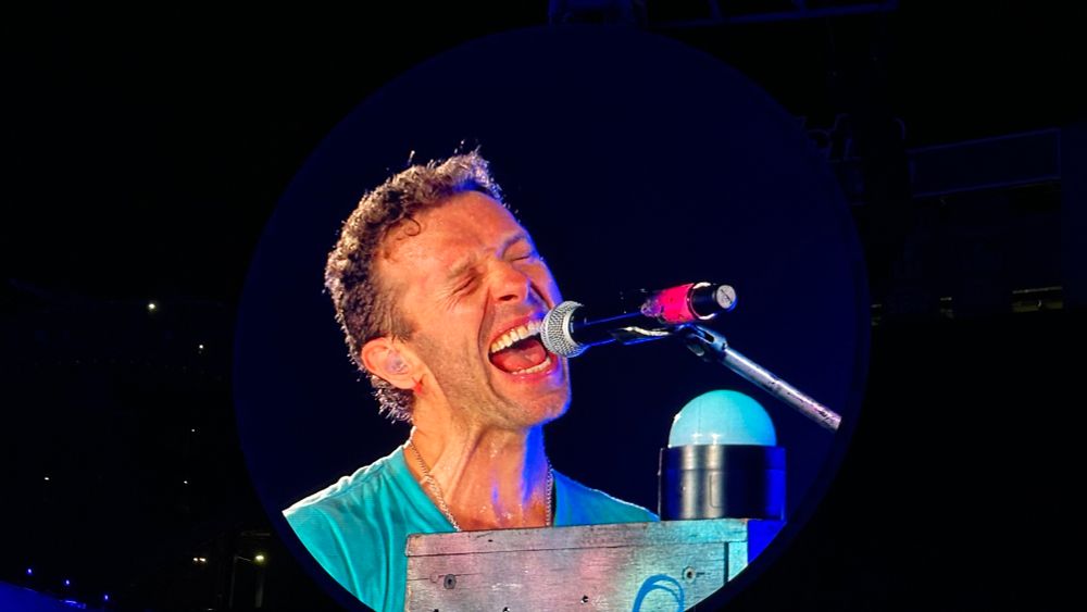 Chris Martin of Coldplay singing to fans.