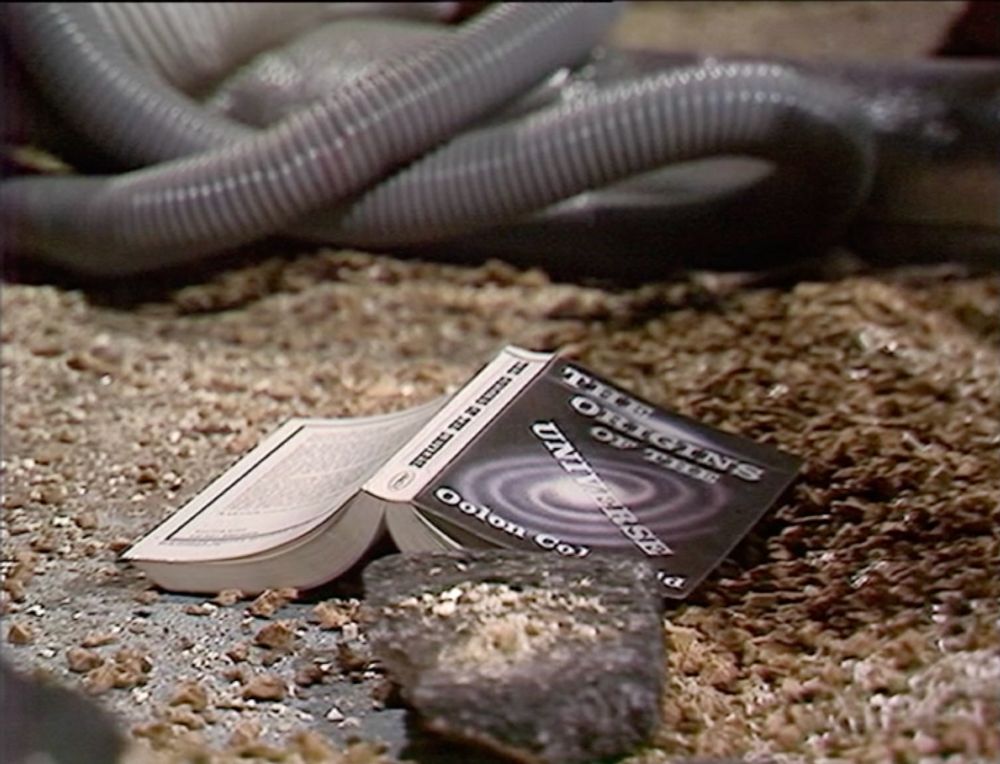 A paperback book The Origins of the Universe by Oolon Colluphid