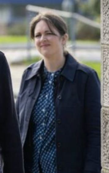 Tosh looks pained, to the left.