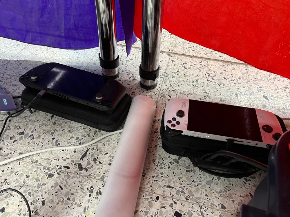 a picture of a steam deck and rog ally, connected to docks