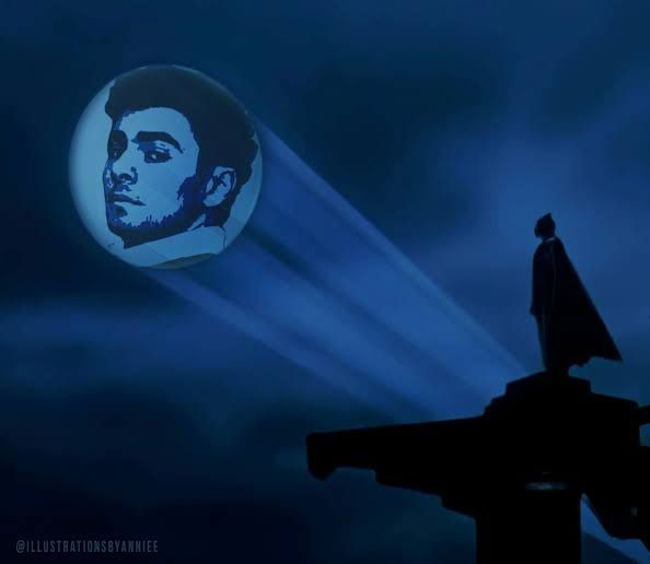 Image of Batman looking at the bat symbol projected up into a dark blue sky but it’s Luigi Mangione’s head inside the circle of light instead