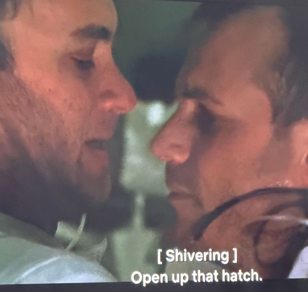 Tom Hanks face to face with Bill paxton with the caption open up that hatch