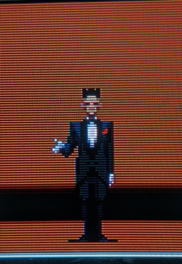 A man in a tux beckons you 