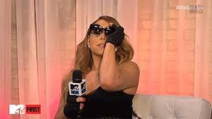 Queen Mariah Carey putting on sunglasses at a MTV interview approximately 800 years ago