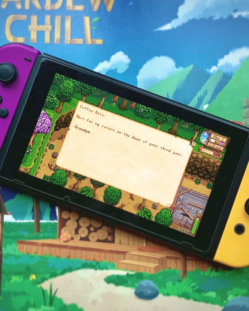A Nintendo Switch set on top of the vinyl jacket for Stardew & Chill. The screen shows a screenshot from Stardew Valley. The screenshot is of an in-game letter reading, "Coffee Date- Wait for my return on the dawn of your third year. - Grandpa".