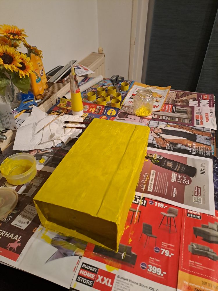 Cardboard box painted yellow.