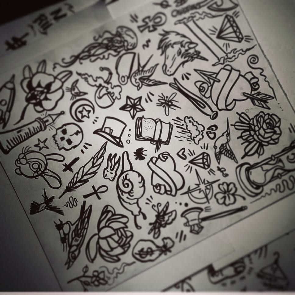 tattoo flash sheet with snails, books, hearts and moons etc