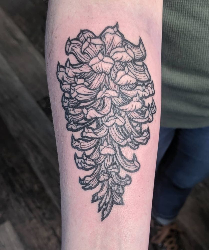 a tattoo of a pinecone done all in linework