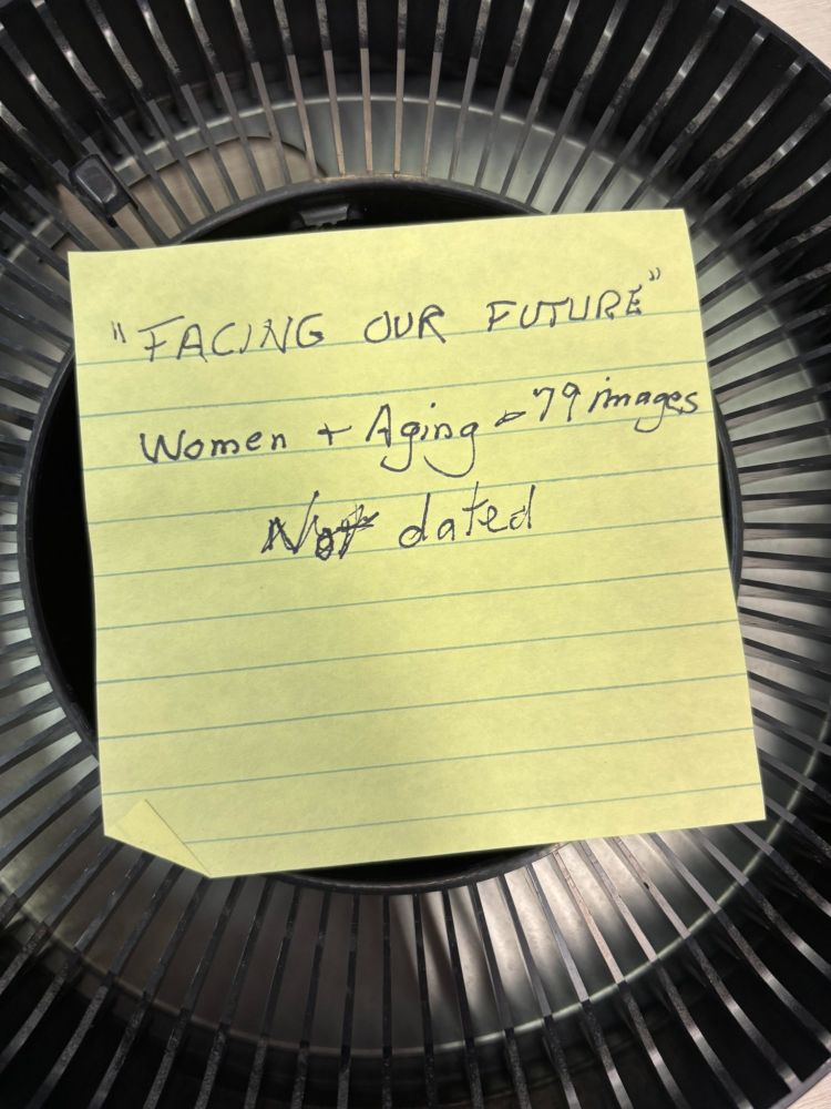 An empty slide carousel with a paper resting on top which reads: "FACING OUR FUTURE" Women + Aging - 79 images Not dated