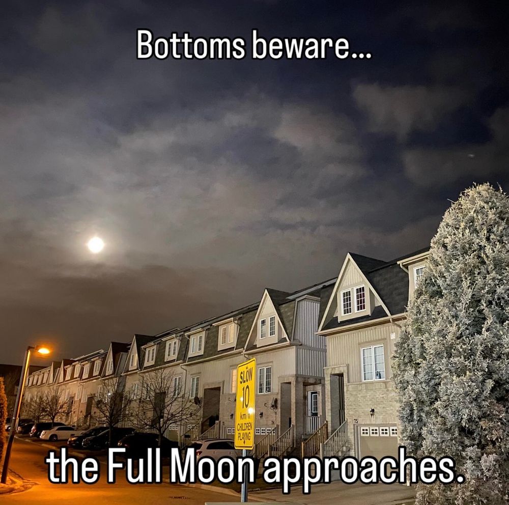A row of houses in the night, with a full moon visible behind clouds in the back.

Overlaid, the text says “Bottoms beware… the Full Moon approaches.”