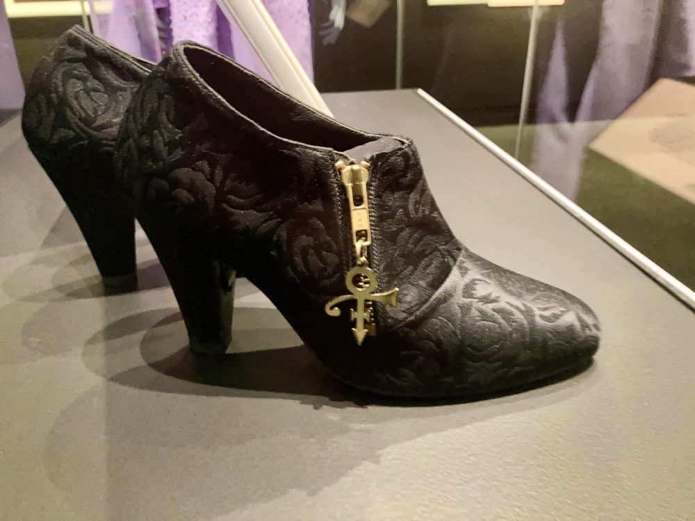 Prince's shoes with his symbol on the zip.