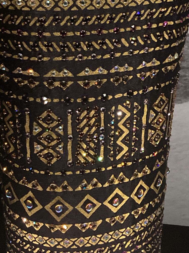 Detail of the gold detailing and beadwork on the dress.