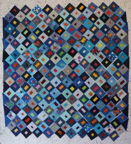 The design is the same, except there is a new dark square in the top left corner. The left side and right side of the design have triangles added to fill in the empty zigzags. At this stage nothing is sewn, so I can move the squares around when I feel like it.