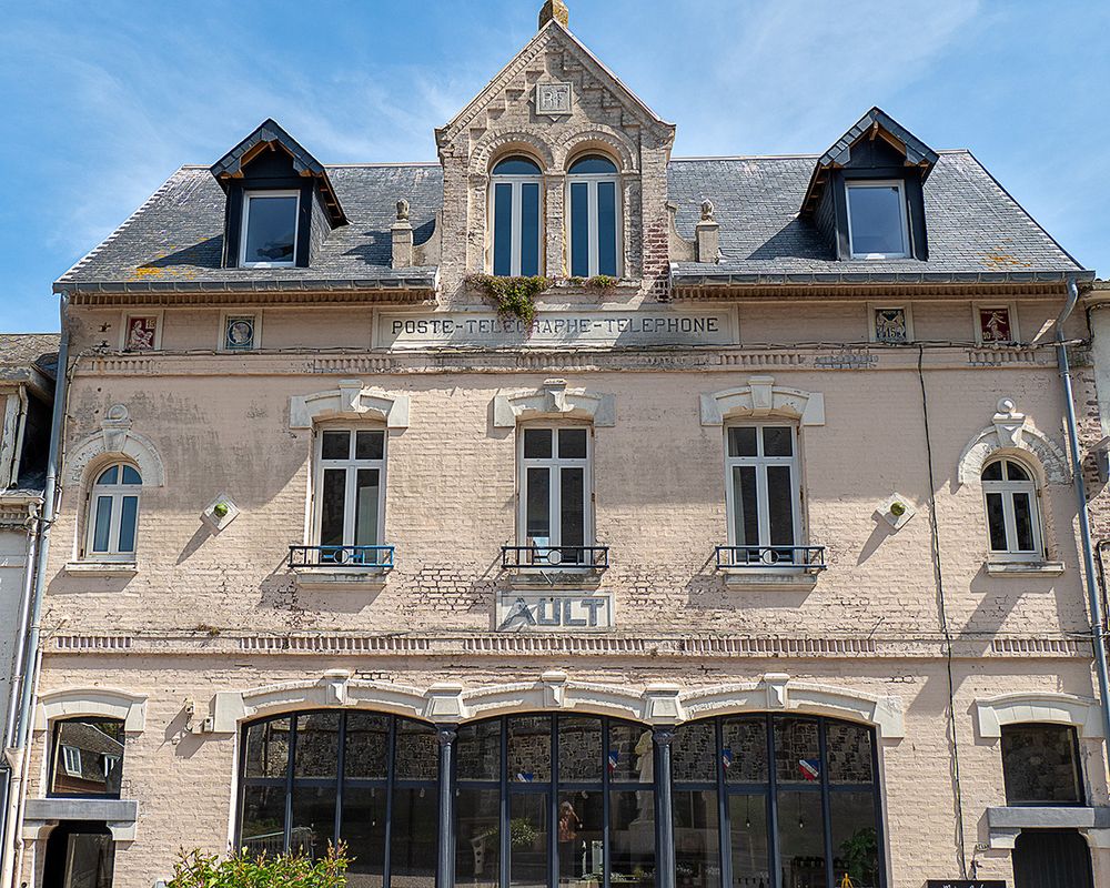 If you look closely you can see representations of different French postage stamps just underneath the eaves of the roof.