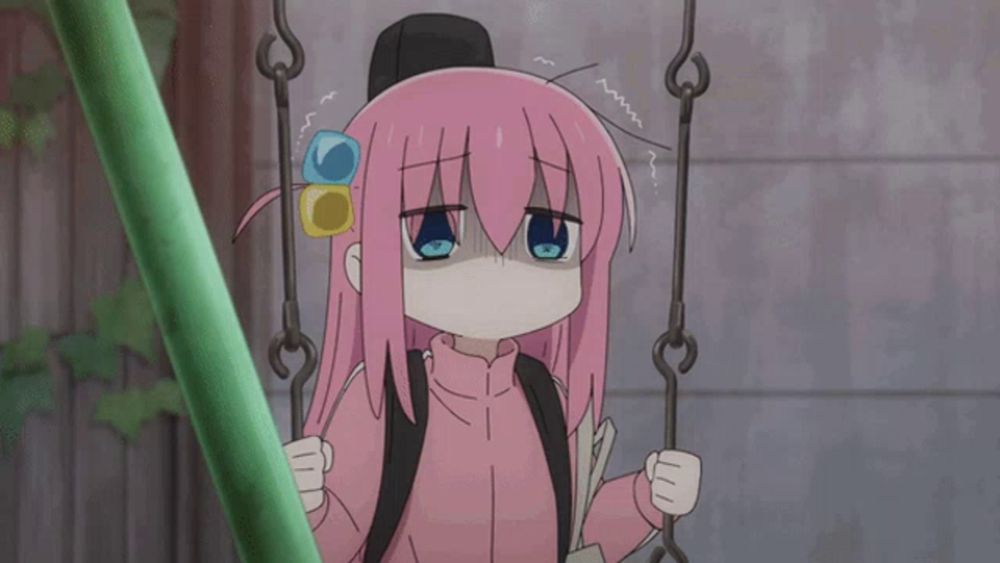 a girl with pink hair is sitting on a swing with her eyes closed